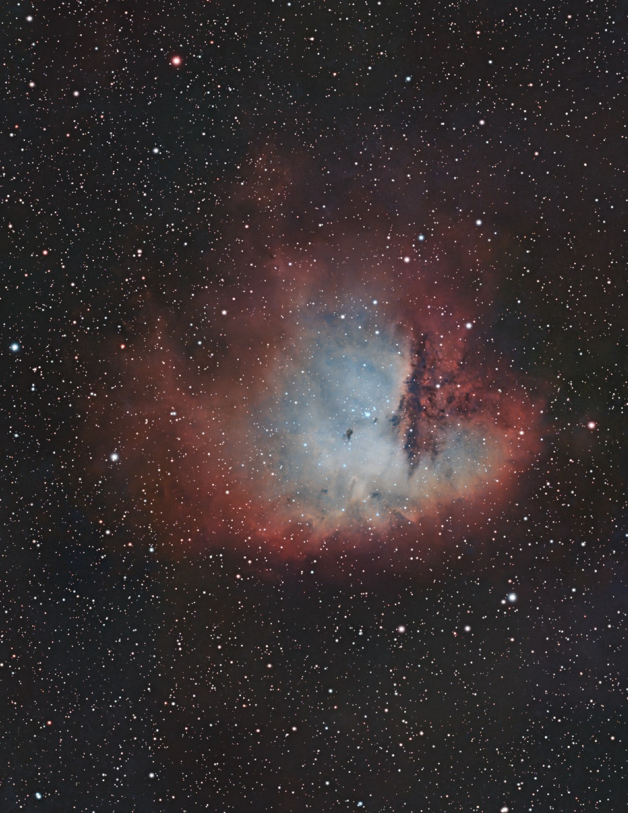 The same nebula mapped to two-gas colour, red hydrogen around a teal oxygen core